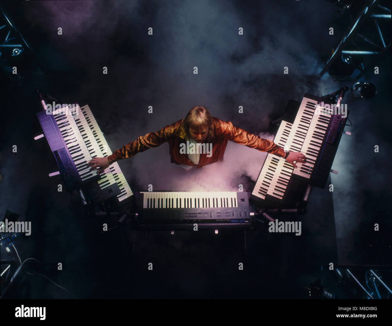 Rick Wakeman playing keyboards shot from overhead  1987 Stock Photo