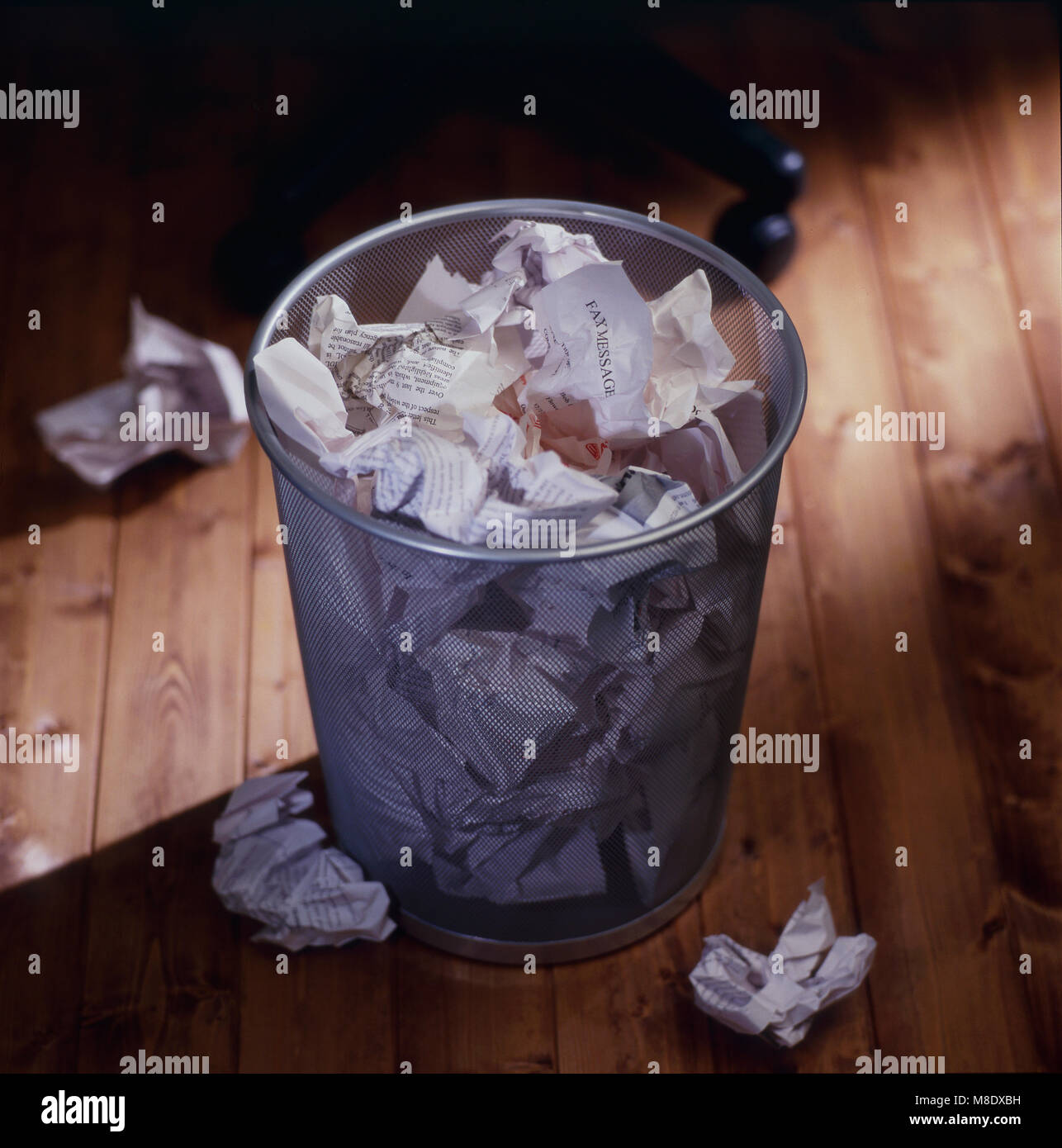 Office waste bin full of wastepaper Stock Photo Alamy