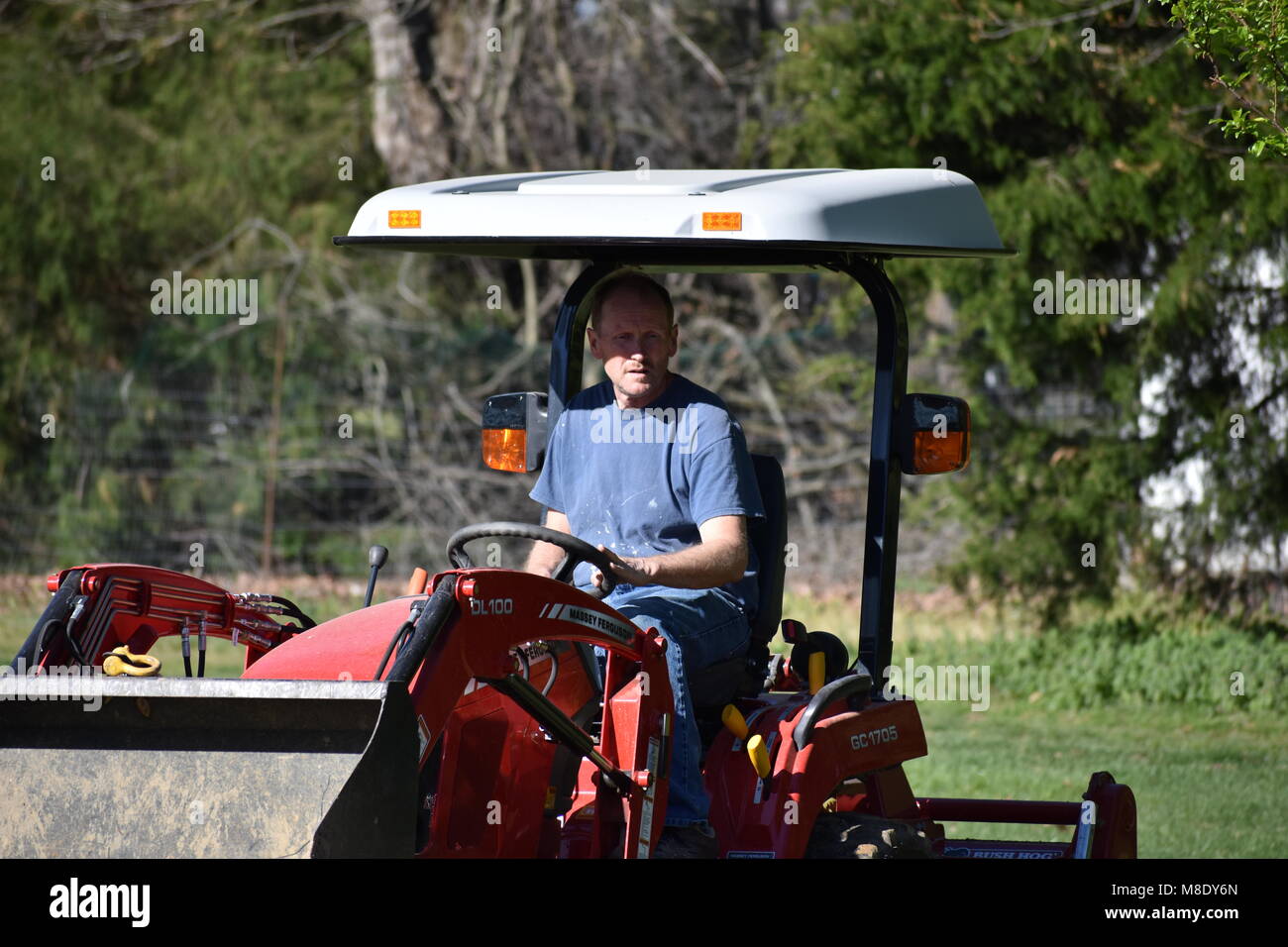 man on tractor plows garden Stock Photo