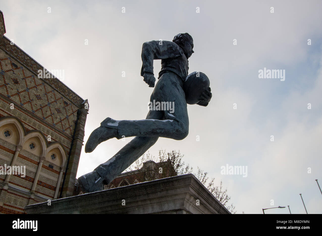 The statue of a young William Webb Ellis who invented Rugby outside Rugby School in the town centre of Rugby. Stock Photo