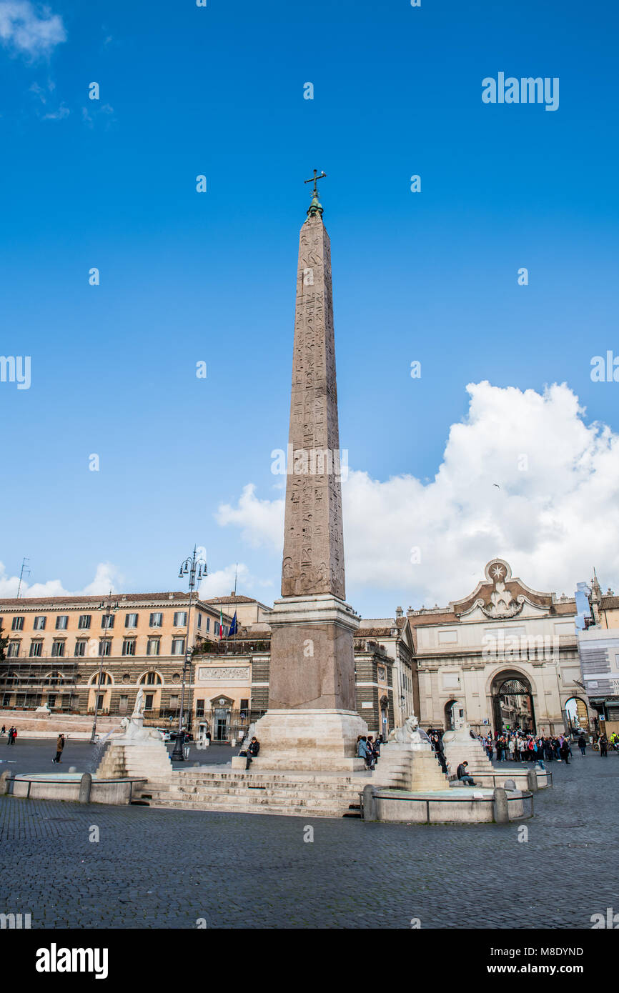 Famous egyptian obelisk and fountains in piazza del popolo, Rome Italy against blue sky and white clouds Stock Photo