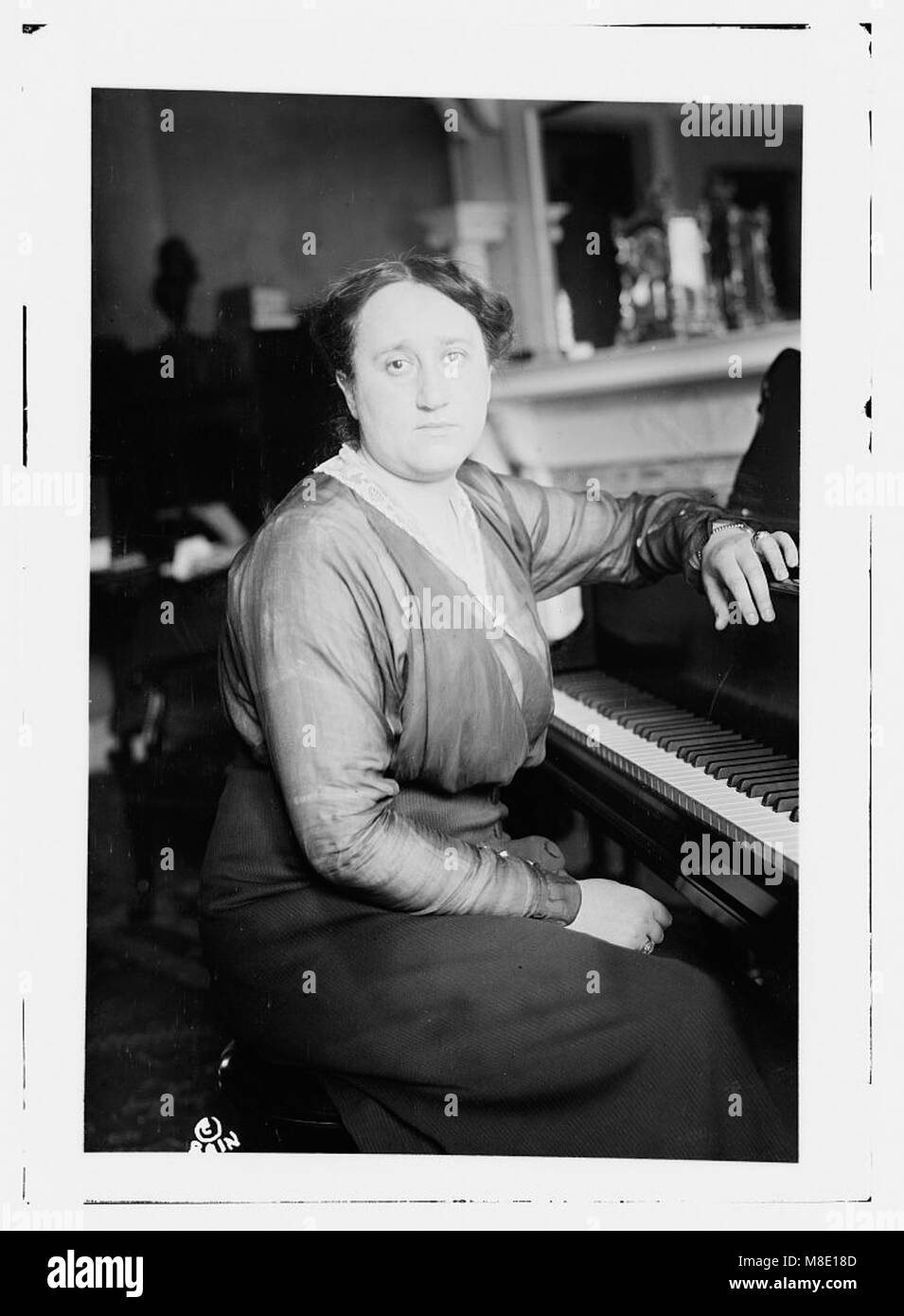 Photograph of Melanie Kurt, captured for her professional portfolio. The image showcases her profile, emphasizing her presence and attire in a studio or indoor setting. The photograph reflects her style and persona. Stock Photo