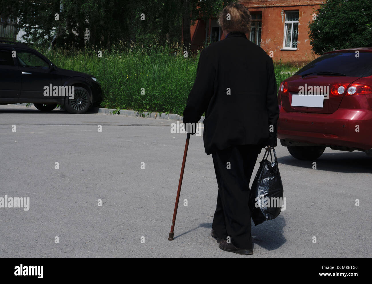 The old man walking in the park with a cane Stock Photo - Alamy