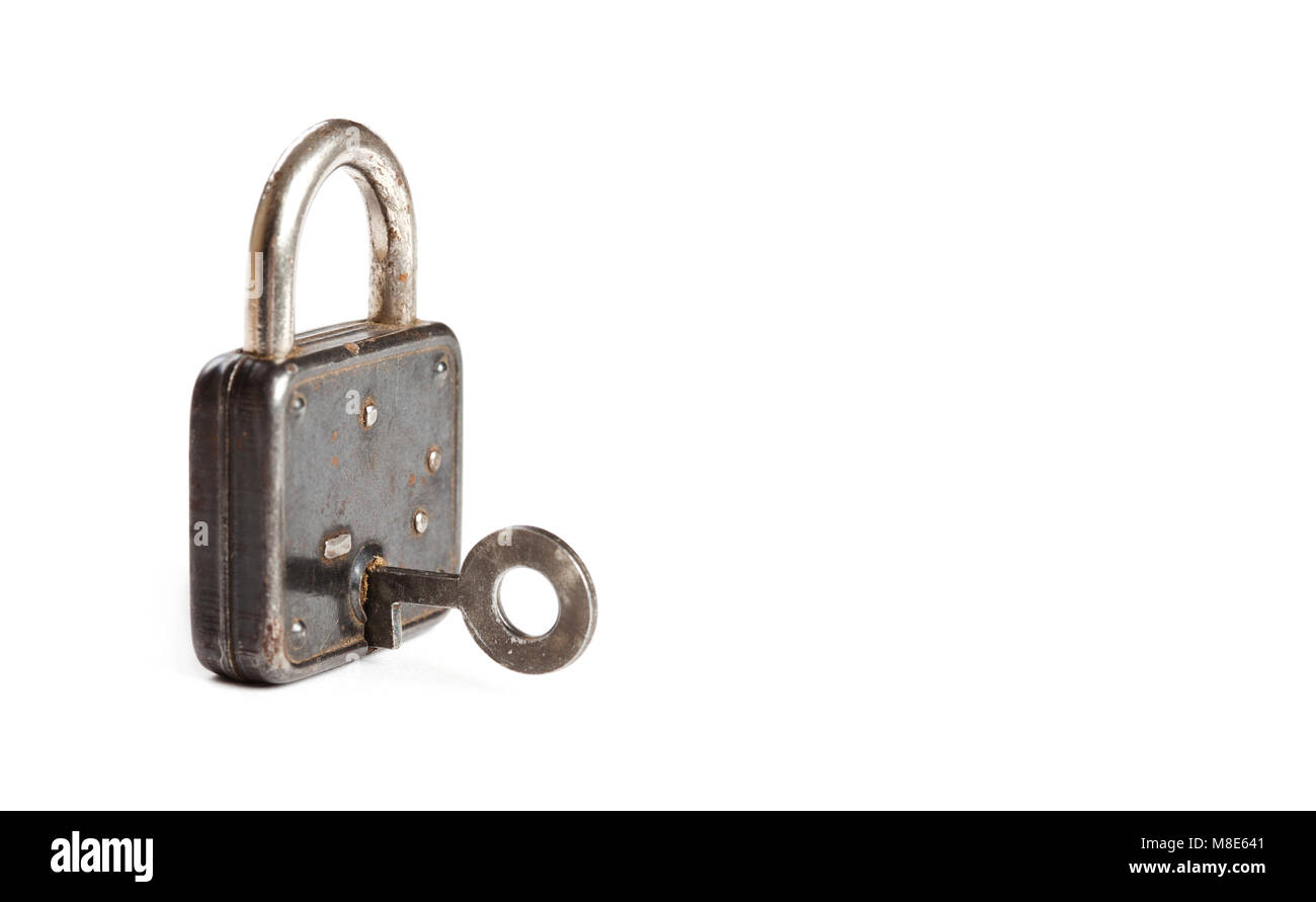 Vintage padlock with key in hole. hanging lock close-up. texture and detailed. white background Stock Photo