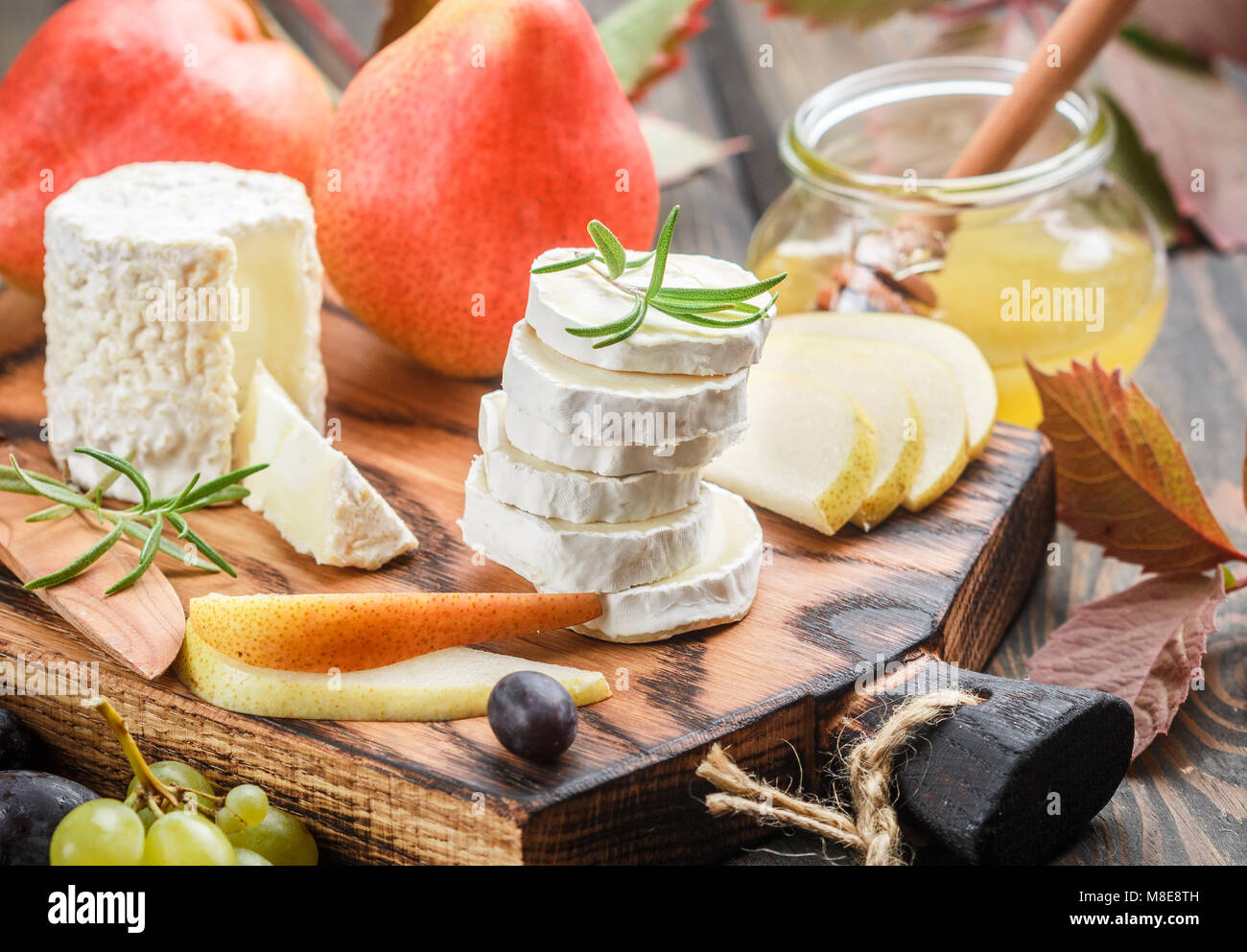 Goat cheese with fruit and honey. Camembert. Bree. Grape, pear and