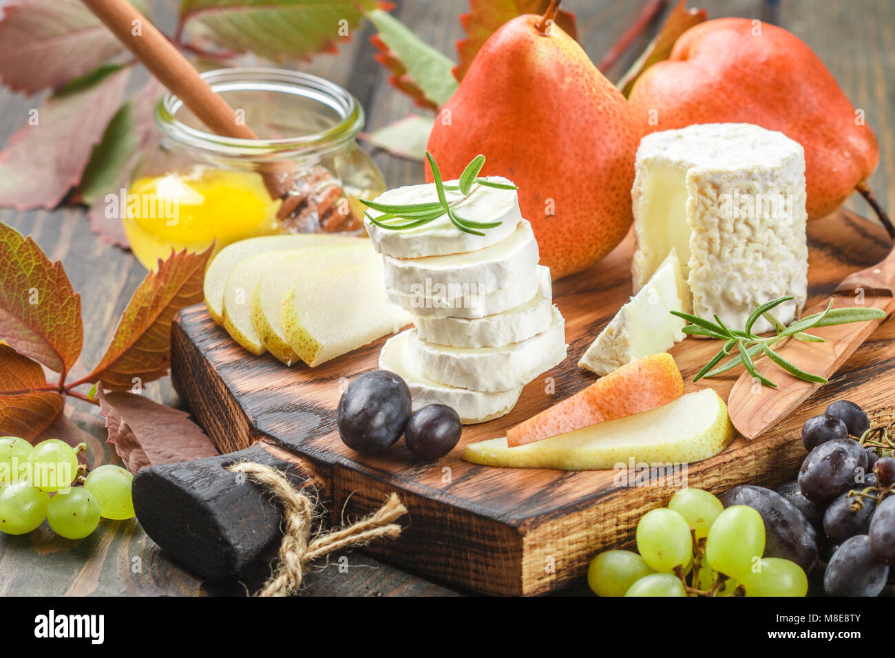 Goat cheese with fruit and honey. Camembert. Bree. Grape, pear and
