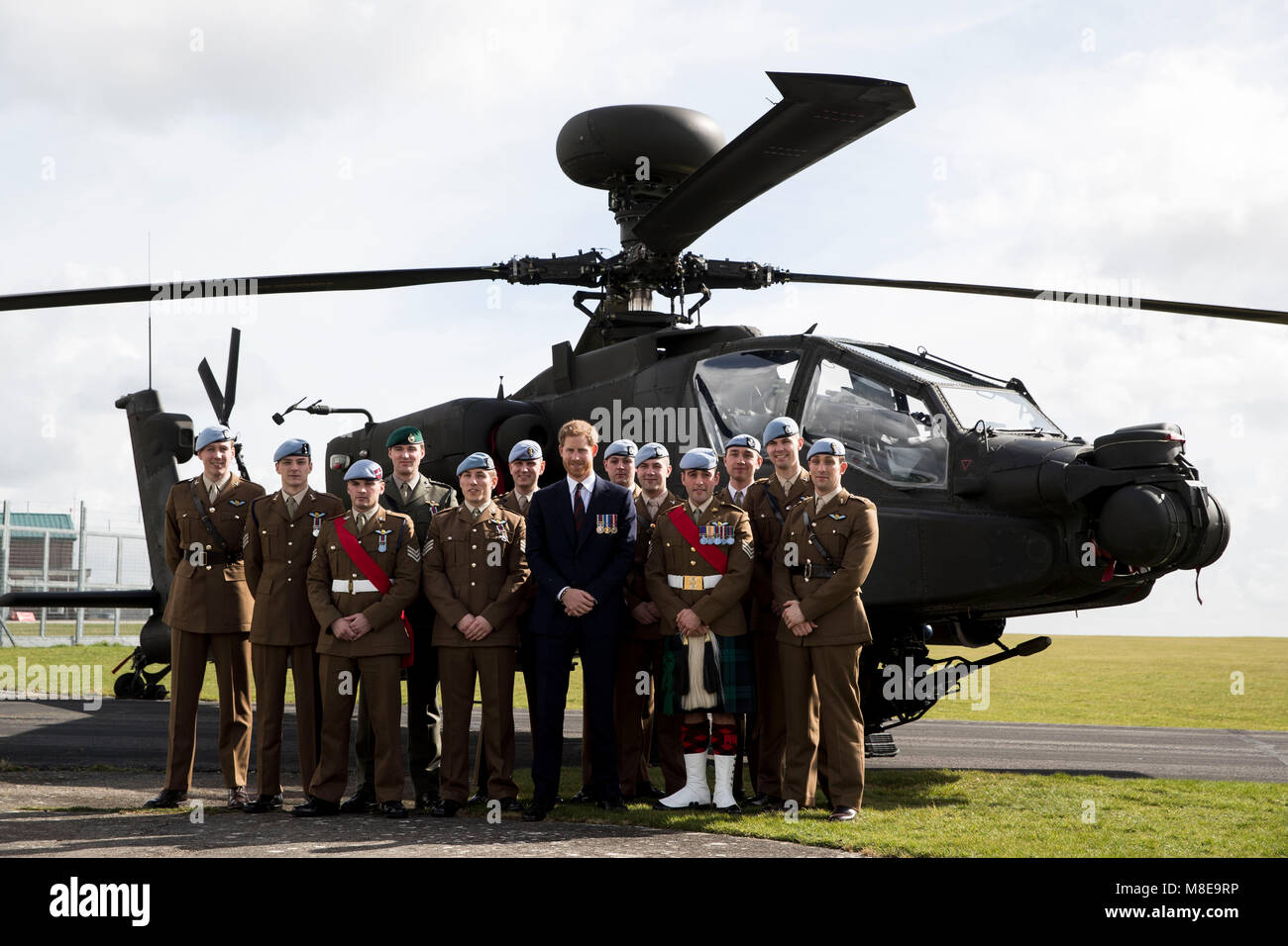 Prince Harry (centre right) poses for a photograph in front of an