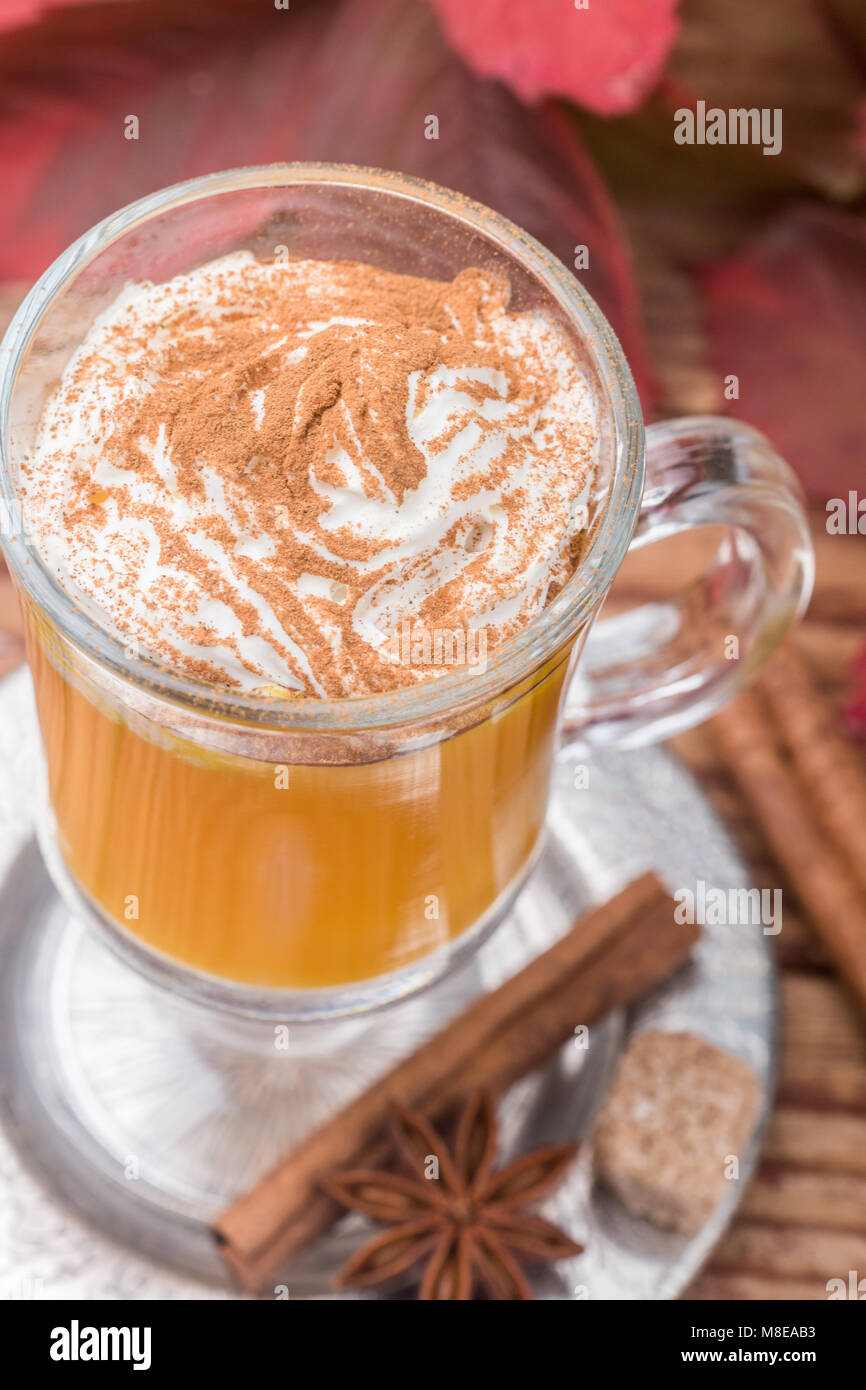 Pumpkin spice latte smoothie with whipped cream and cinnamon in glass ...