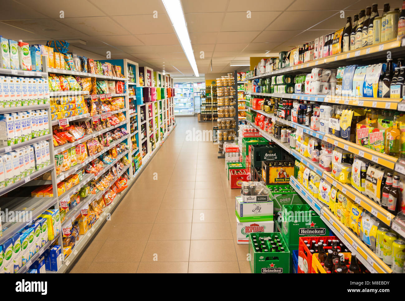 super market in Holland with racks full of food, like drinks and fastfood and racks with beer Stock Photo
