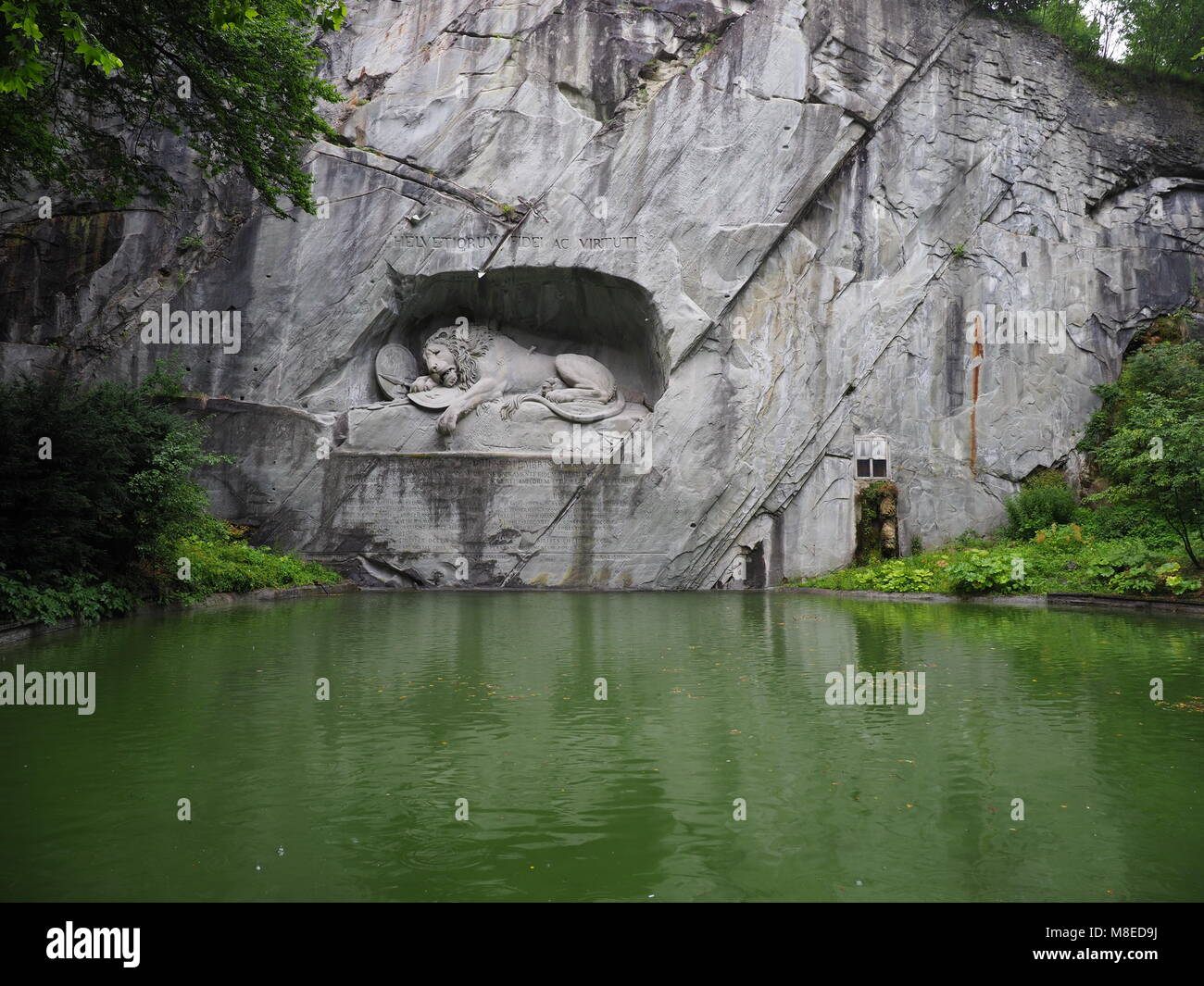 Rock Relief Of Lion Monument In Stone Wall With Water Reflection In Stock Photo Alamy