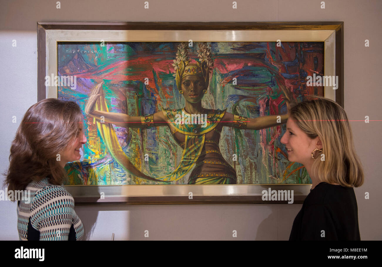 Bonhams, New Bond Street, London, UK. 16 March 2018. Laser light is used to square up the painting of Balinese Dancer by Vladimir Tretchikoff being hung for the Bonhams South African Art sale. Credit: Malcolm Park/Alamy Live News. Stock Photo