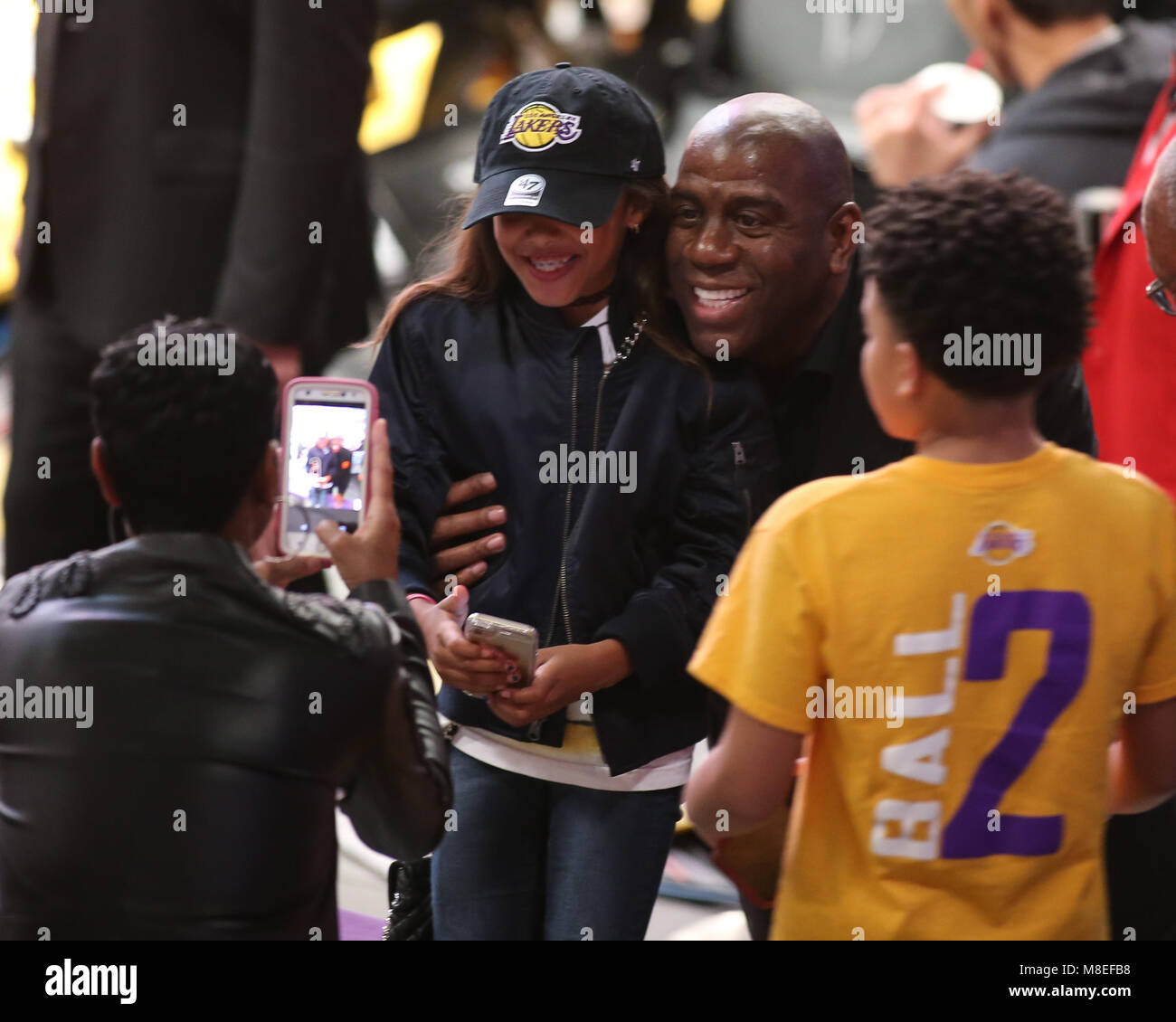 Magic Johnson of the Lakers arriving at the Los Angeles Coliseum dressed in Raiders  gear to watch an L.A. Raiders NFL football game in 1991 Stock Photo - Alamy