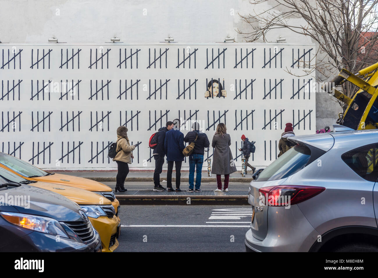 New York, NY, USA. 16th March, 2018. - Photographers and art lovers flock to Houston Street to view one of two new pieces by Street Artist, Banksy. Banksy unveiled the work Thursday which highlights the case of a Turkish artist,  Zehra Doğan was reportedly imprisoned in 2017 for her painting of a damaged Turkish city.  Credit: Stacy Walsh Rosenstock/Alamy Live News Stock Photo