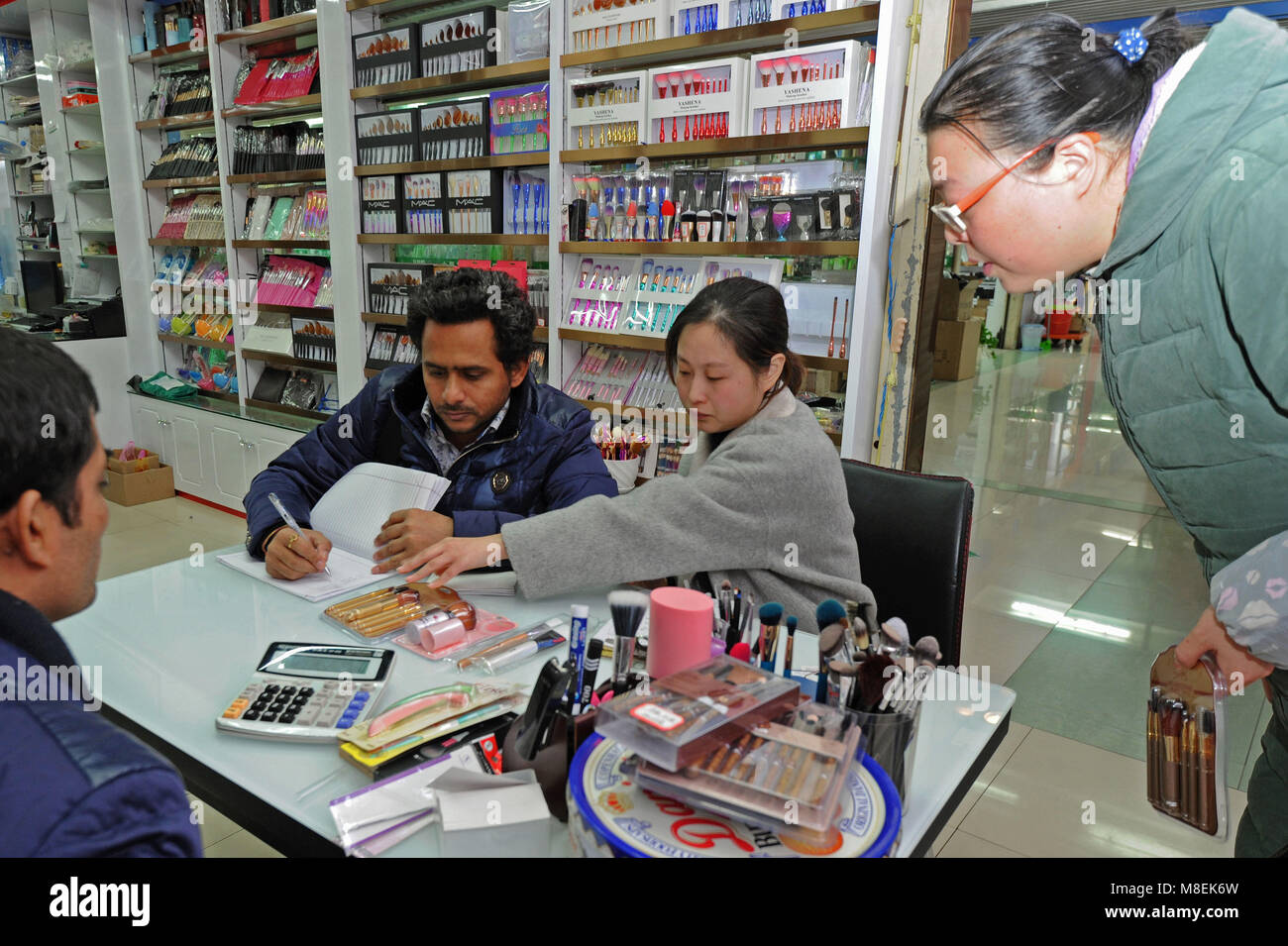 (180317) -- YIWU, March 17, 2018 (Xinhua) -- An Indian businessman (2nd L) checks the purchase list at the international shopping mall in Yiwu, a city specialized in small goods trade in east China's Zhejiang Province, Jan. 4, 2018. Zhejiang's trade with countries and regions related to China's Belt and Road Initiative reached 149.89 billion yuan (23.68 billion U.S. dollars) in the first two months of 2018, growing 37.3 percent year on year and accounting for 11.9 percent of China's total, according to the latest figures issued by the Hangzhou Customs. (Xinhua/Tan Jin) (ry) Stock Photo