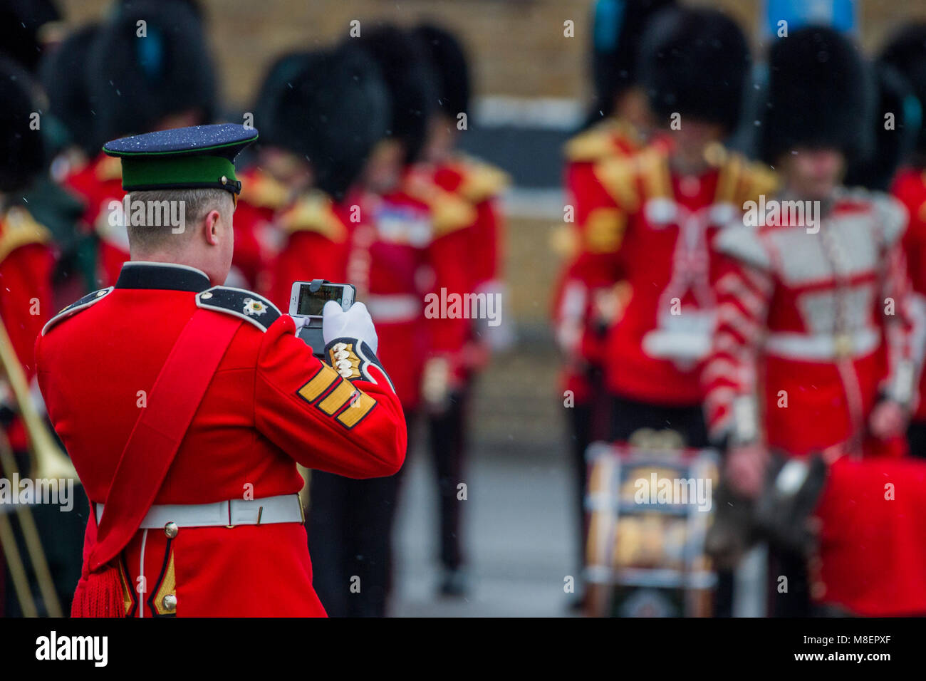 London, UK, 17 Mar 2018. Even Sergeants use phone cameras - The Duke of Cambridge, Colonel of the Irish Guards, accompanied by The Duchess of Cambridge, visited the 1st Battalion Irish Guards at their St. Patrick's Day Parade. Credit: Guy Bell/Alamy Live News Stock Photo