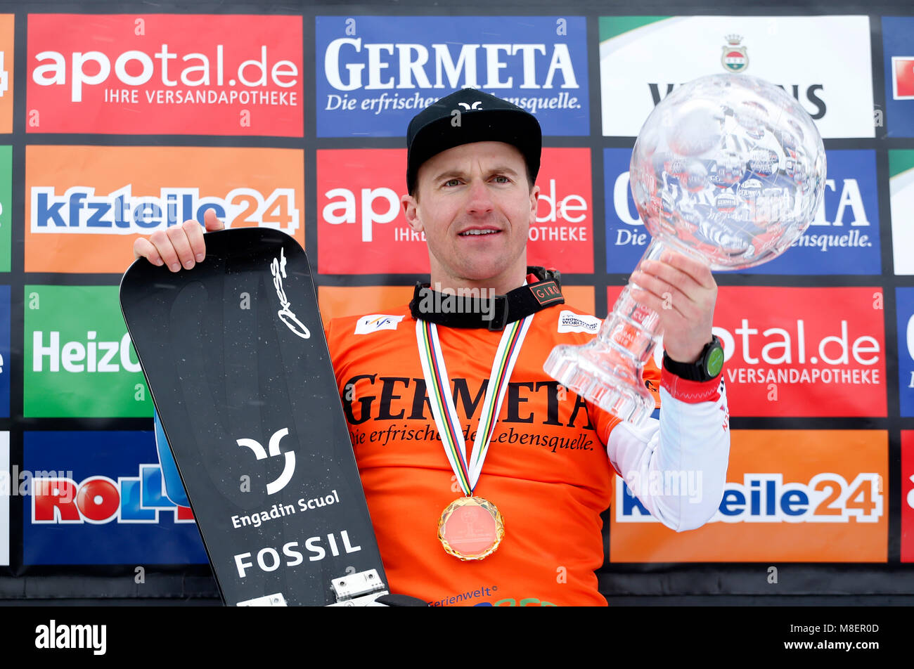 Winterberg, Germany, 17 March 2018, Snowboard World Cup, parallel slalom, men's single. Nevin Galmarini of Switzerland celebrates at the victory ceremony for the overall world cup. Photo: Ina Fassbender/dpa Stock Photo