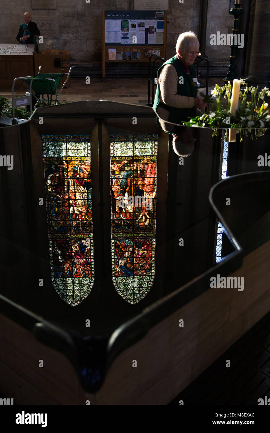 A woman arranges flowers at Salisbury Cathedral in Salisbury, Wiltshire