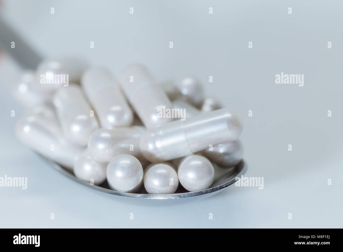 Medication in pill form on a spoon Stock Photo Alamy