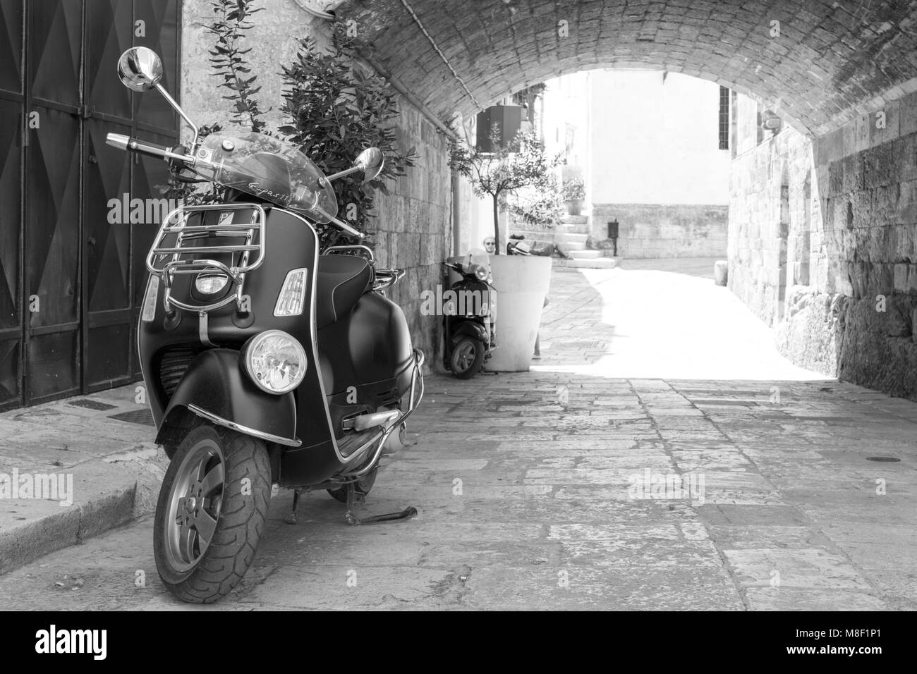 Vespa under a stone bridge of Ostuni, Italy Stock Photo Alamy