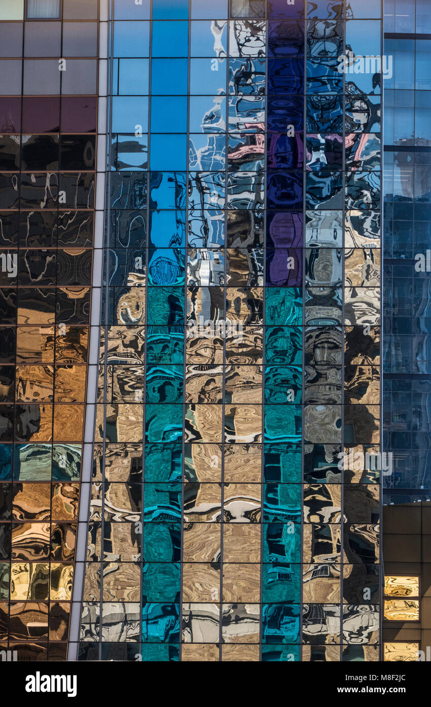 Colorful mosaic of reflections in a glass and steel building In lower Manhattan, New York City USA Stock Photo