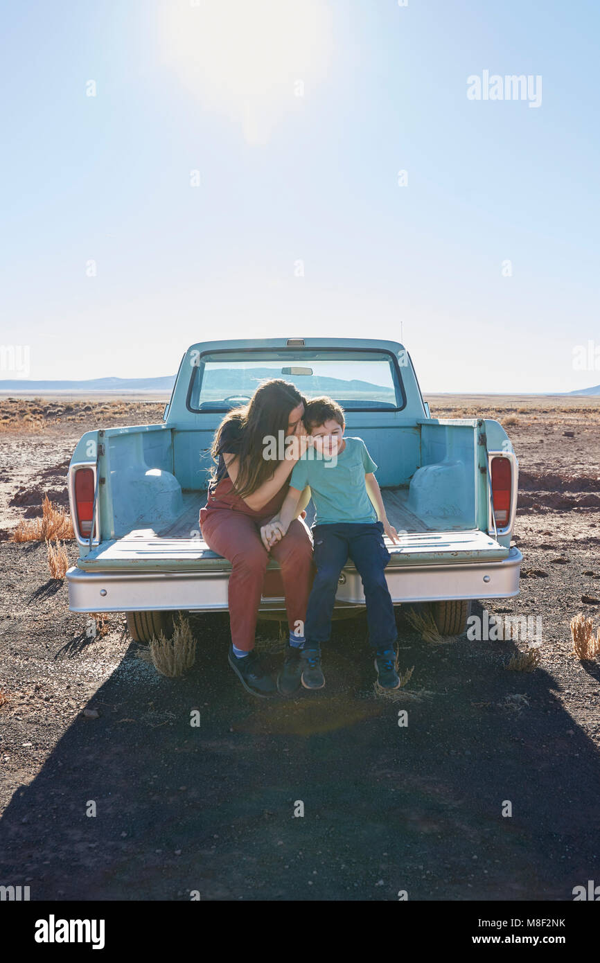 USA, Arizona, Mother with son (6-7) sitting on tailgate of pick-up truck Stock Photo