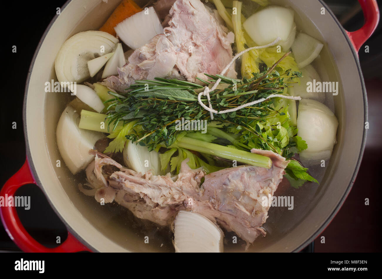 Cooking broth from turkey leftovers and vegetables Stock Photo