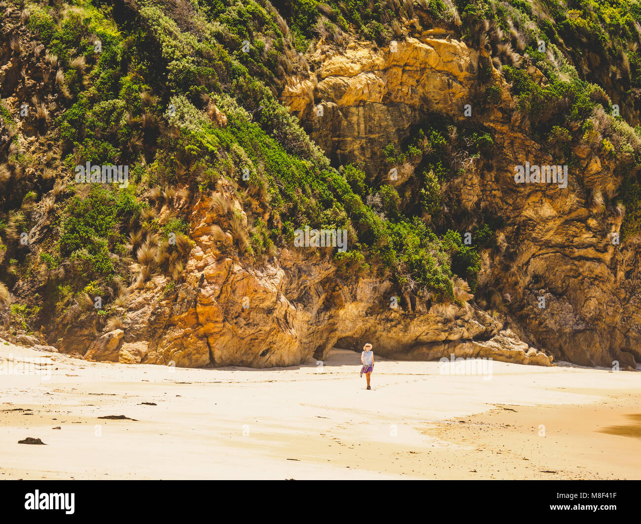 Australia, New South Wales, Bermagui, Woman walking along beach Stock Photo