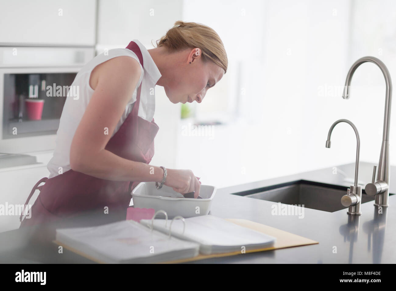 Woman standing at kitchen island hi-res stock photography and images ...