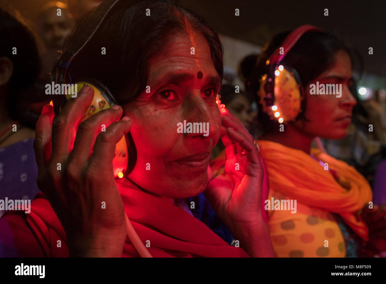 Women listening to pre-recorded fortune telling in Sonepur, India. Stock Photo