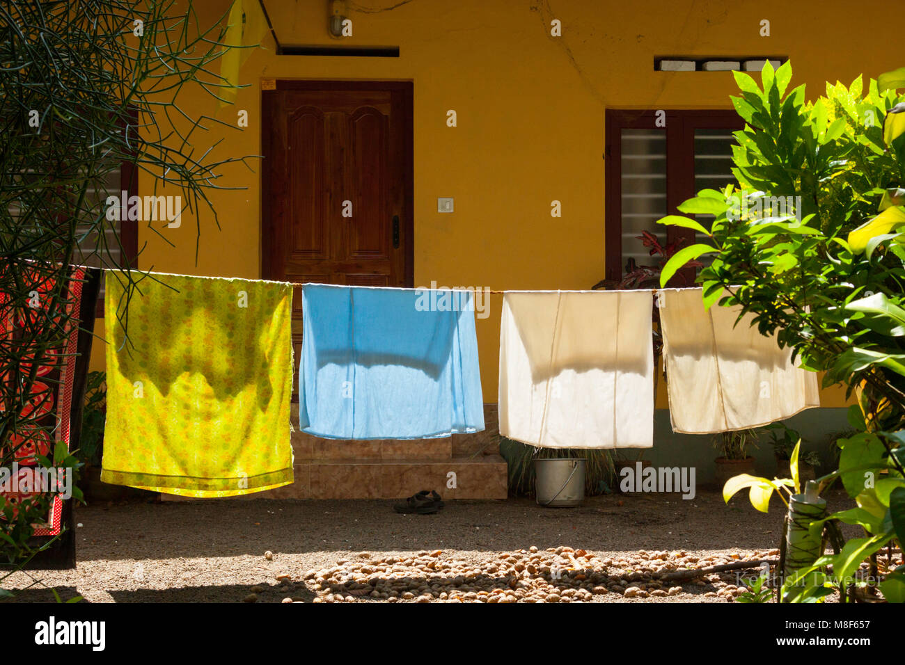 Washing back lit and hanging outside a house on the Kerala Backwaters, India. Stock Photo