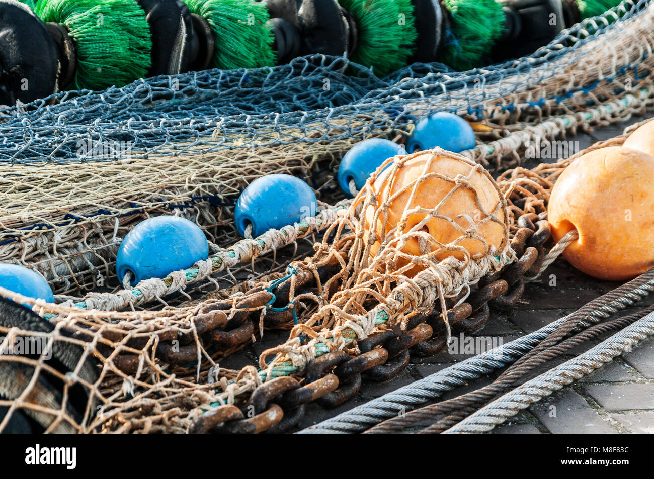 fishing nets spread out on the quay Stock Photo