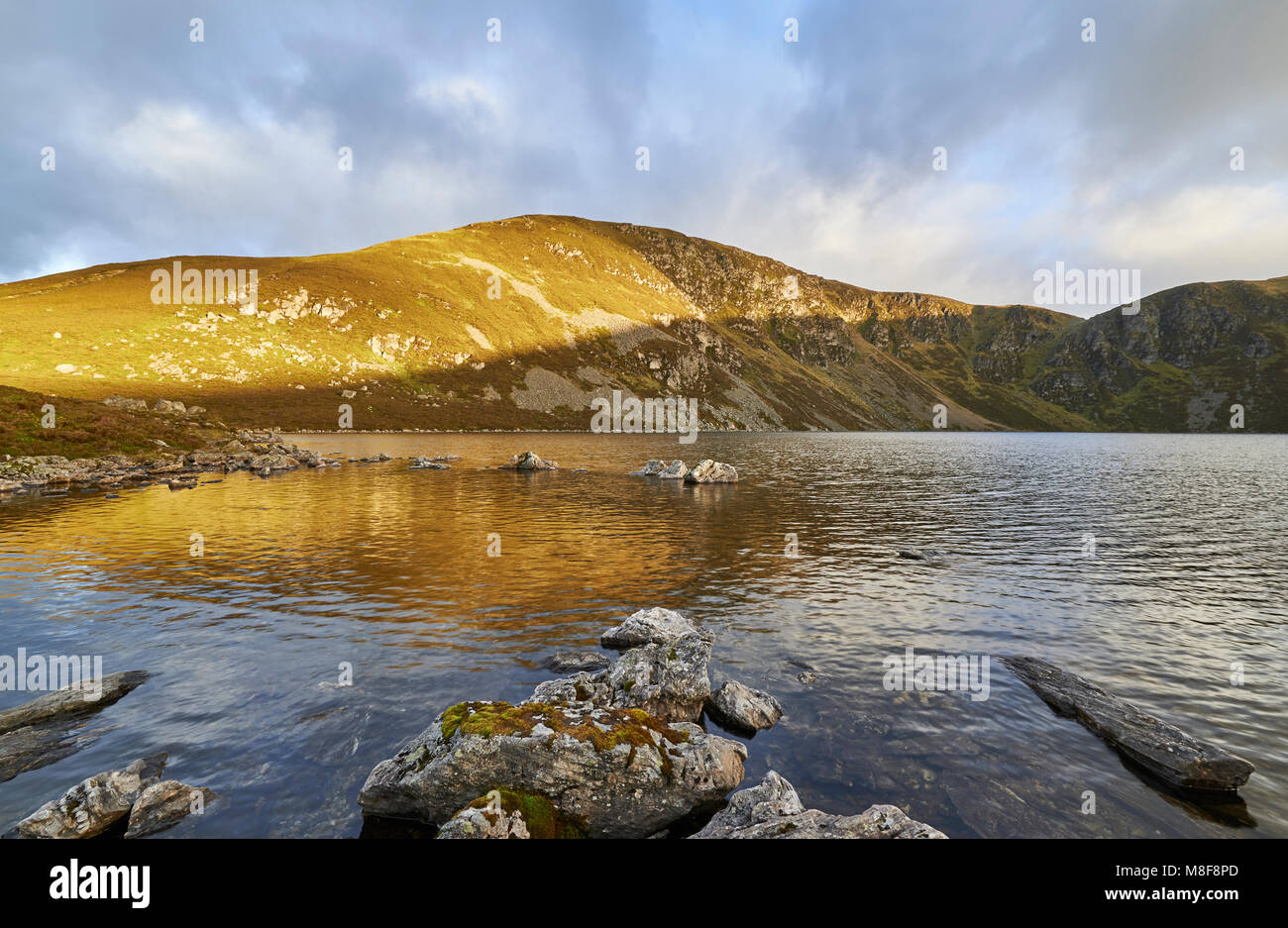 The early morning Autumn light falling across the Mountain overlooking Loch Brandy at Glen Clova, one of the Angus Glens in Scotland. Stock Photo