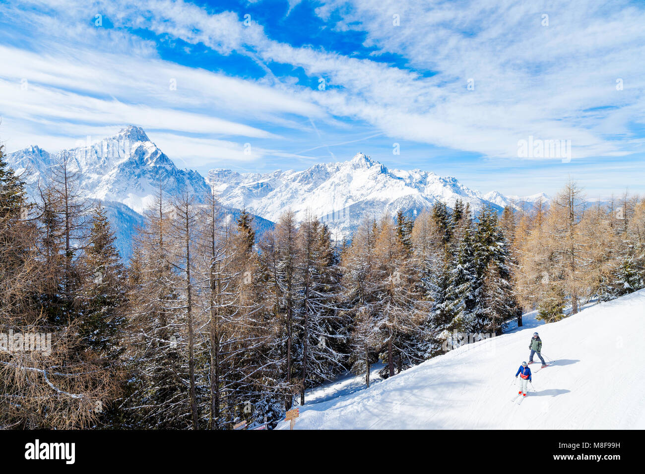 Skiing and snowboarding in high mountains, with Trentino Alto Adige's peaks in the background, San Candido. Italy Stock Photo