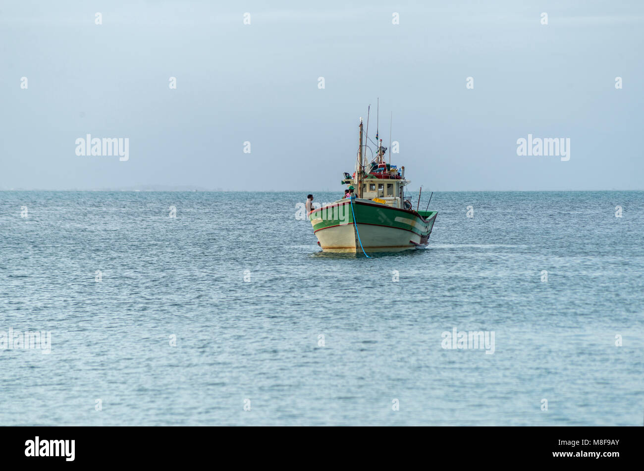 fishing boat anchored with the sea and the blue sky as background Stock ...