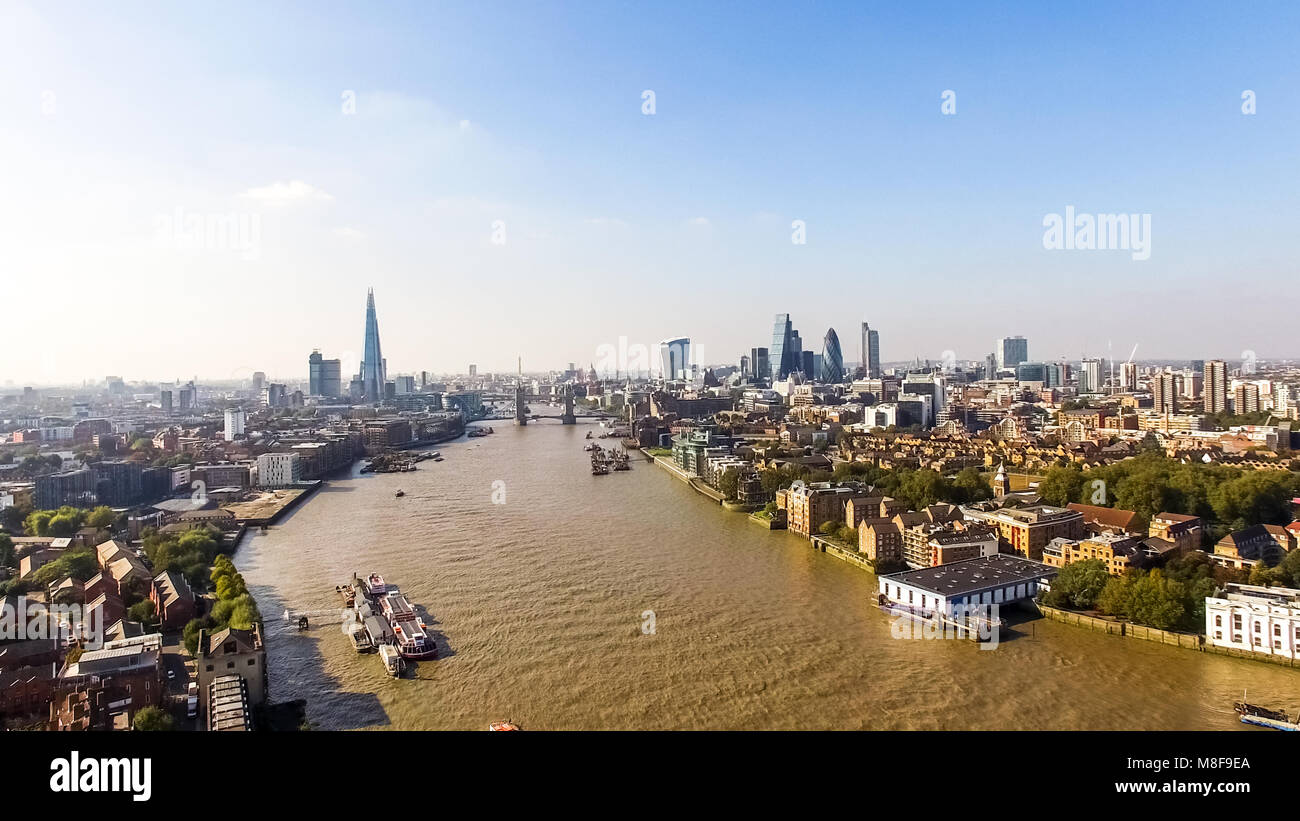 London City Skyline Aerial View feat. Famous Iconic Landmarks Skyscrapers Flying Over Thames River and Tower Bridge in England, United Kingdom 4K Stock Photo