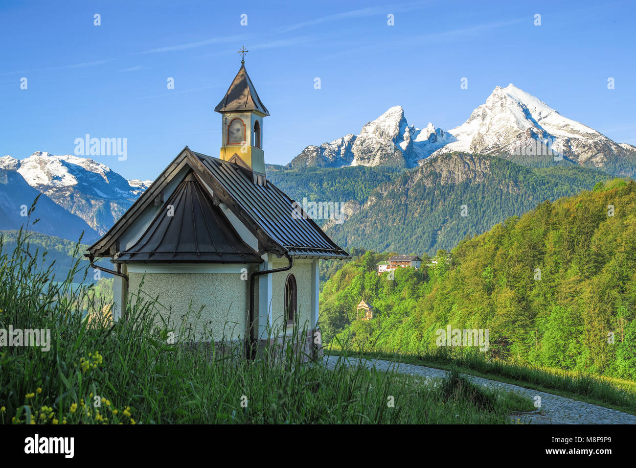 Spring landscape with small chapel and snow-covered Watzmann mountain ...