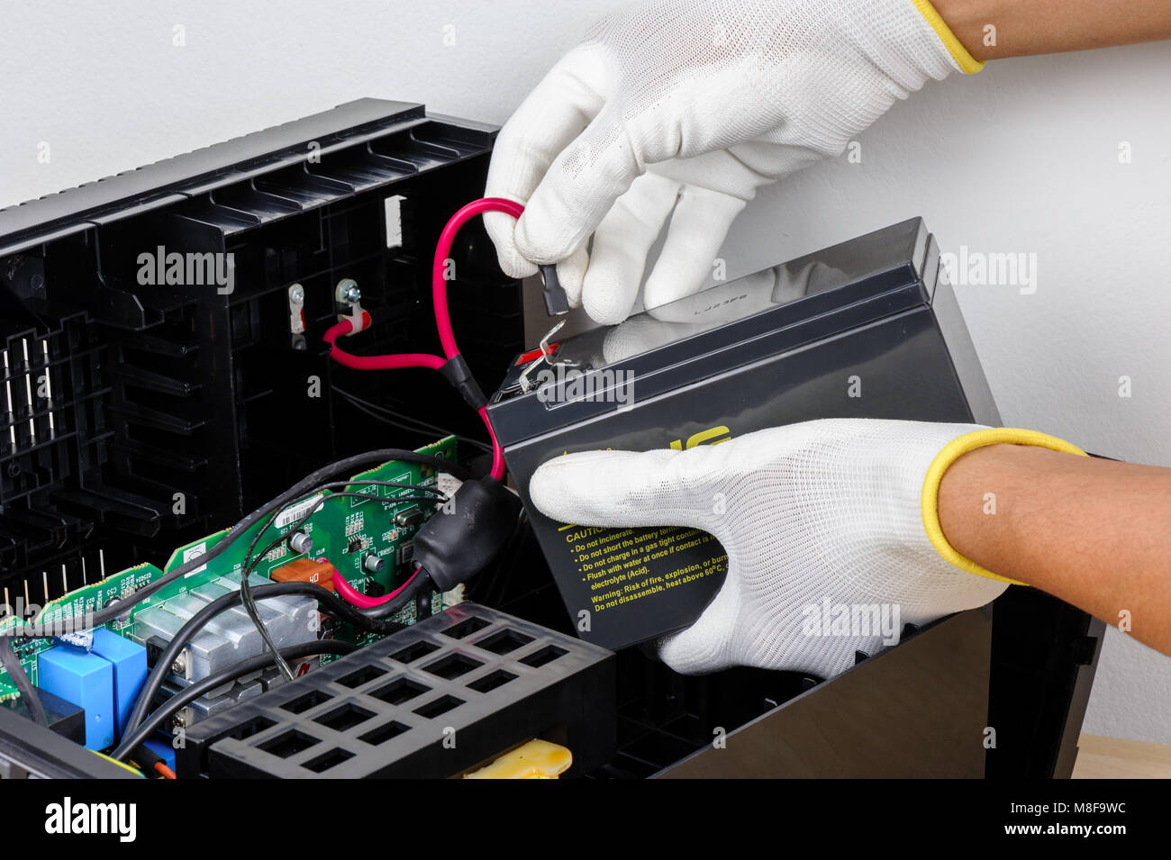 Technician replacing the UPS(Uninterruptible Power Supply) battery Stock Photo Alamy