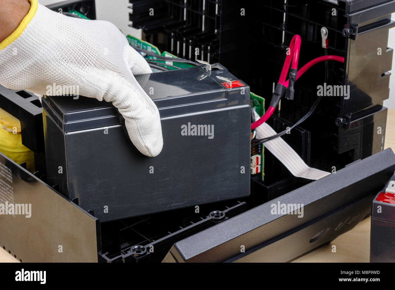 Technician replacing the UPS(Uninterruptible Power Supply) battery