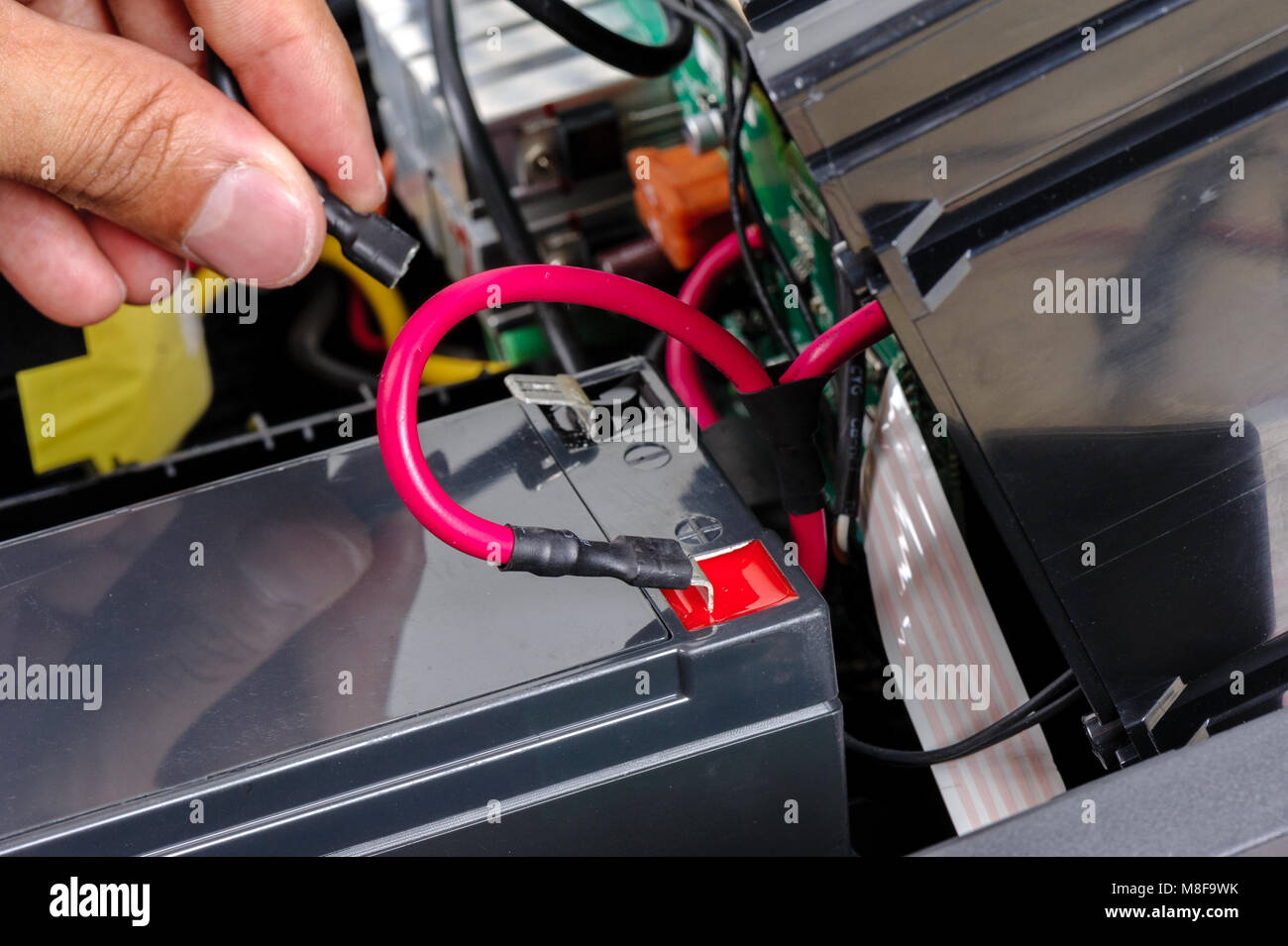 Technician replacing the UPS(Uninterruptible Power Supply) battery