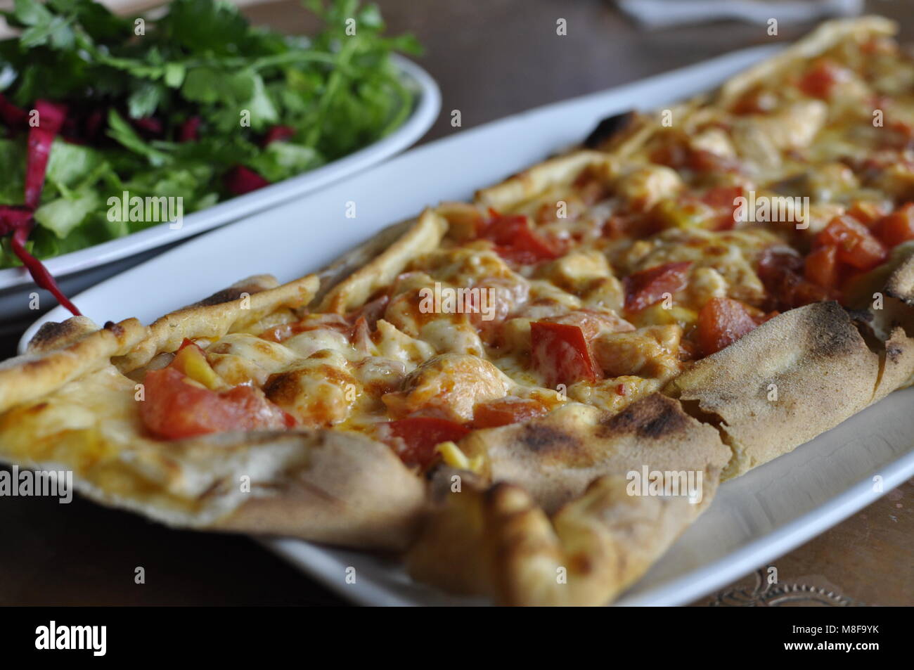 Turkish pizza sitting oven fresh on a plate Stock Photo