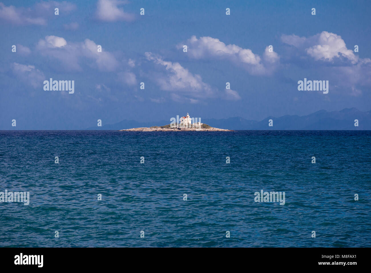 A Small Rocky Island With A Lighthouse In The Mediterranean Sea By