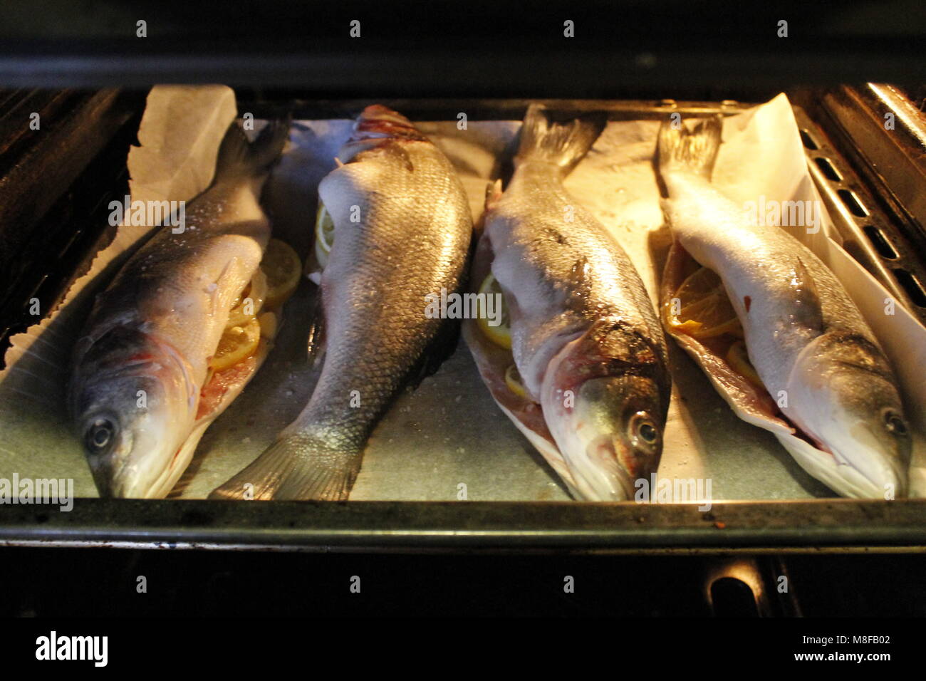 four sea bass cooked in the oven Stock Photo Alamy