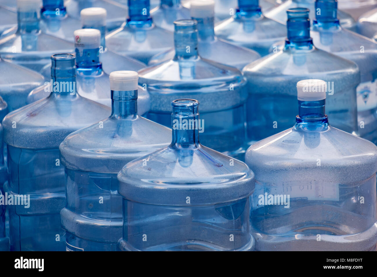 https://c8.alamy.com/comp/M8FDYT/accumulated-water-bottles-on-street-to-pick-by-water-delivery-van-M8FDYT.jpg