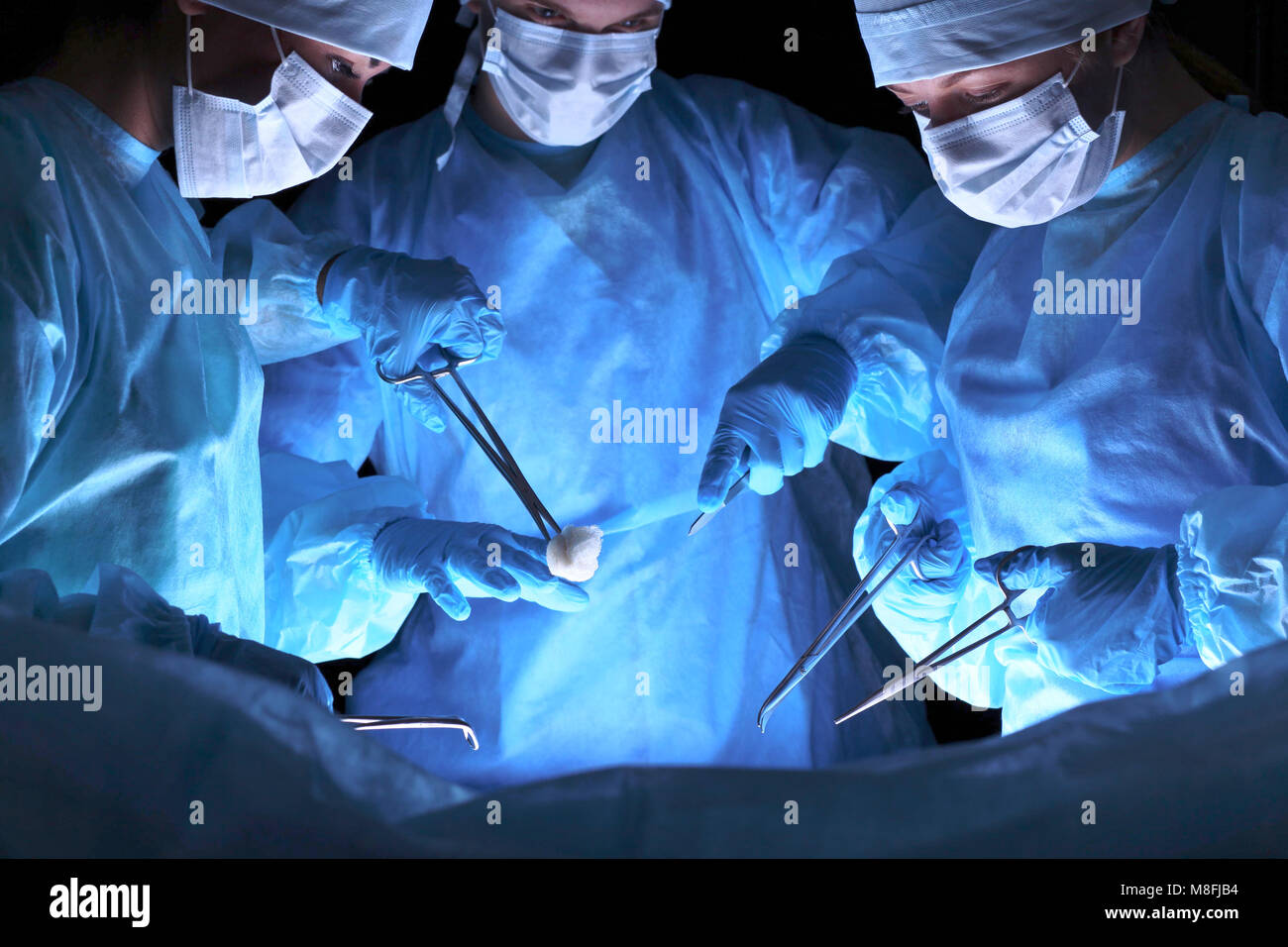 Group of surgeons in masks performing operation. Medicine, surgery and ...