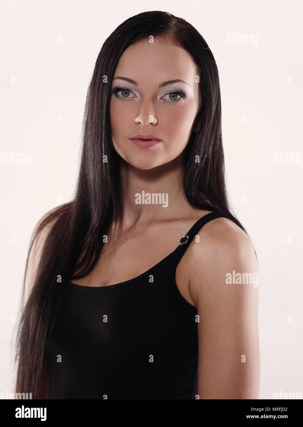 Portrait of beautiful black-haired woman posing on white backgro Stock Photo