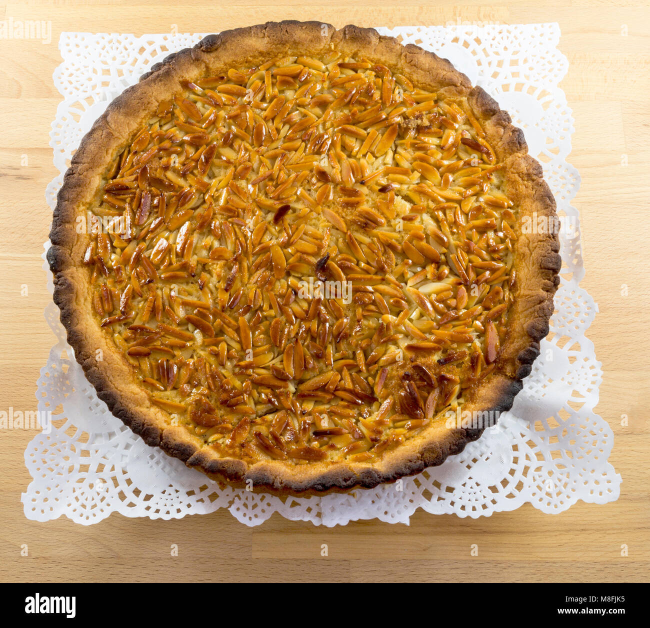 Delicious almond tart with thin crust and caramelized top. Stock Photo