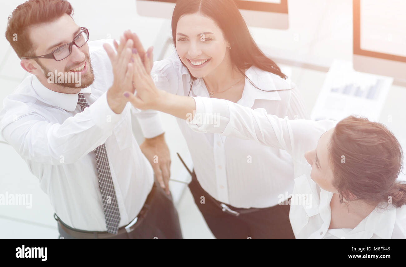 successful business team giving each other a high five Stock Photo - Alamy