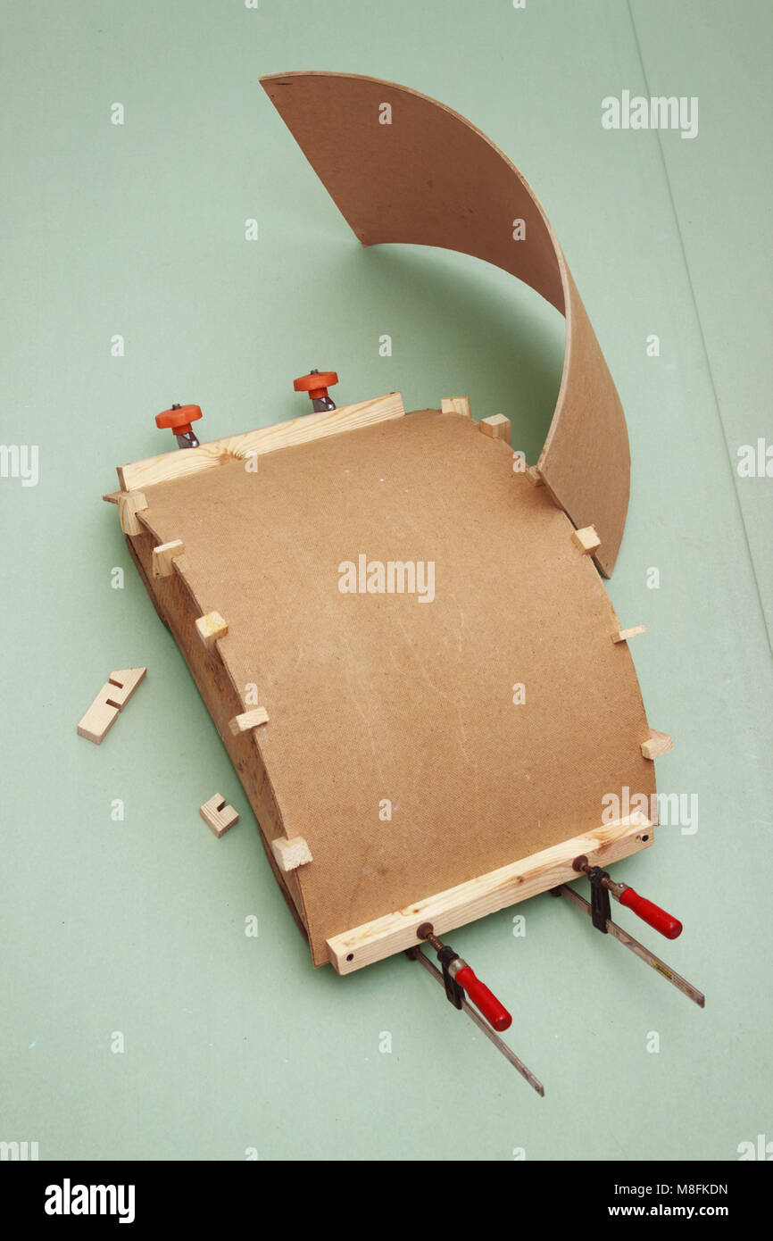 Gluing the workpiece of hardboard using arcuate patterns Stock Photo