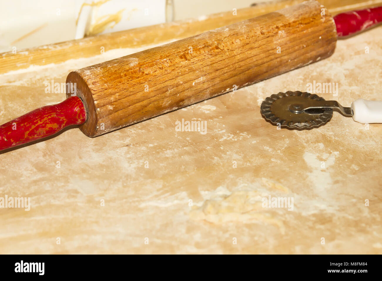 Roller Pin on Wooden Table in Domestic Kitchen Stock Photo