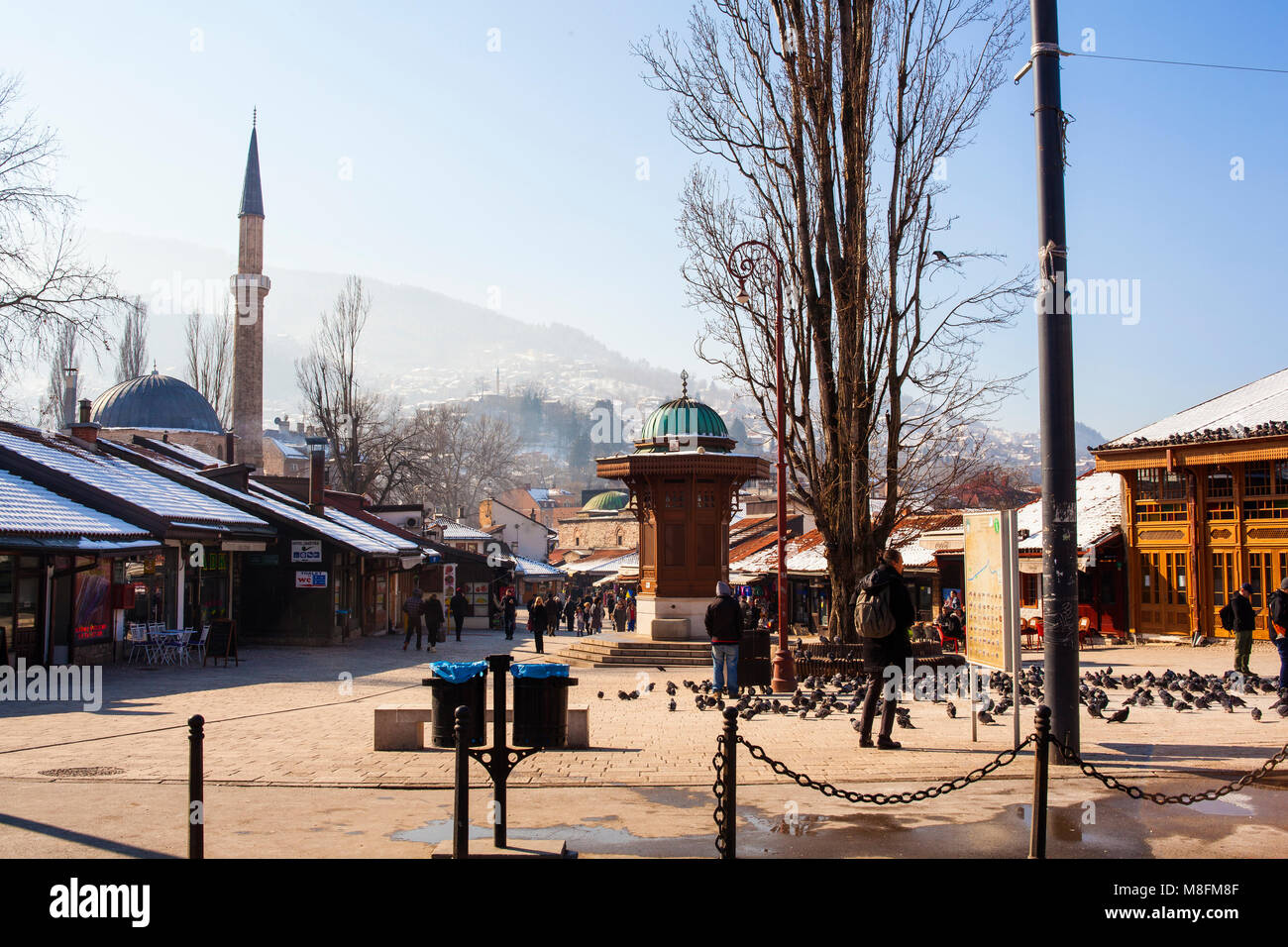 SARAJEVO, BOSNIA-ERZEGOVINA - FEBRUARY, 16:View of the Sebilj wooden fountain and Bascarsijska Dzamija minaret in Bascarsija square on February 16, 20 Stock Photo